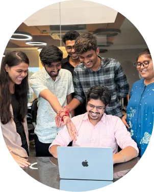 The ByteWeb web engineering team collaborating around a laptop.